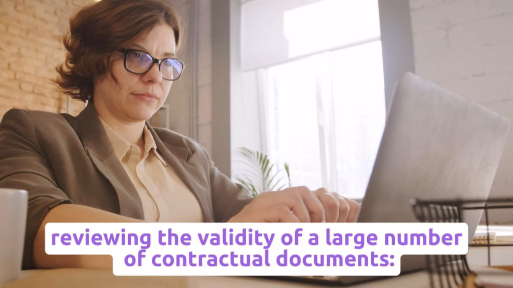 Legal professional reviewing contractual documents on a laptop